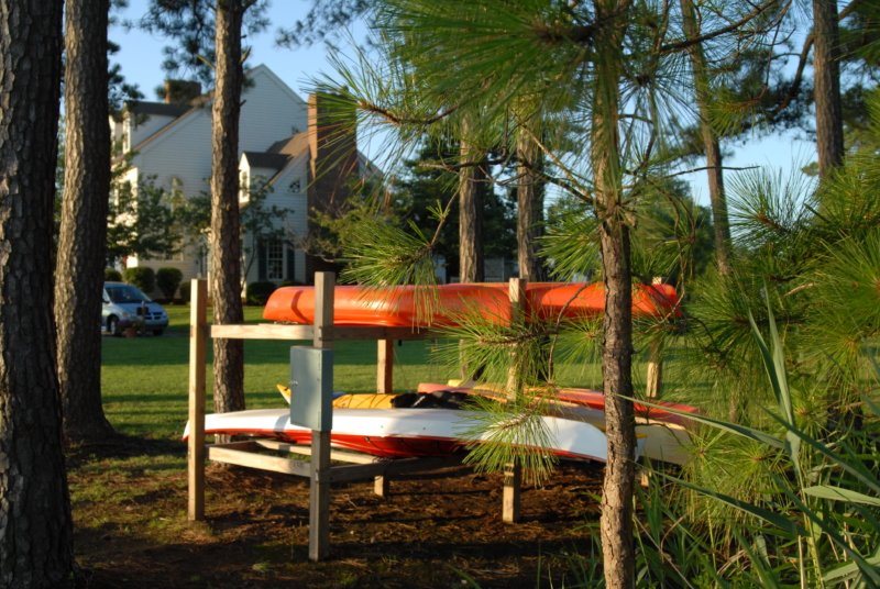Canoes and kayaks stored on rack.