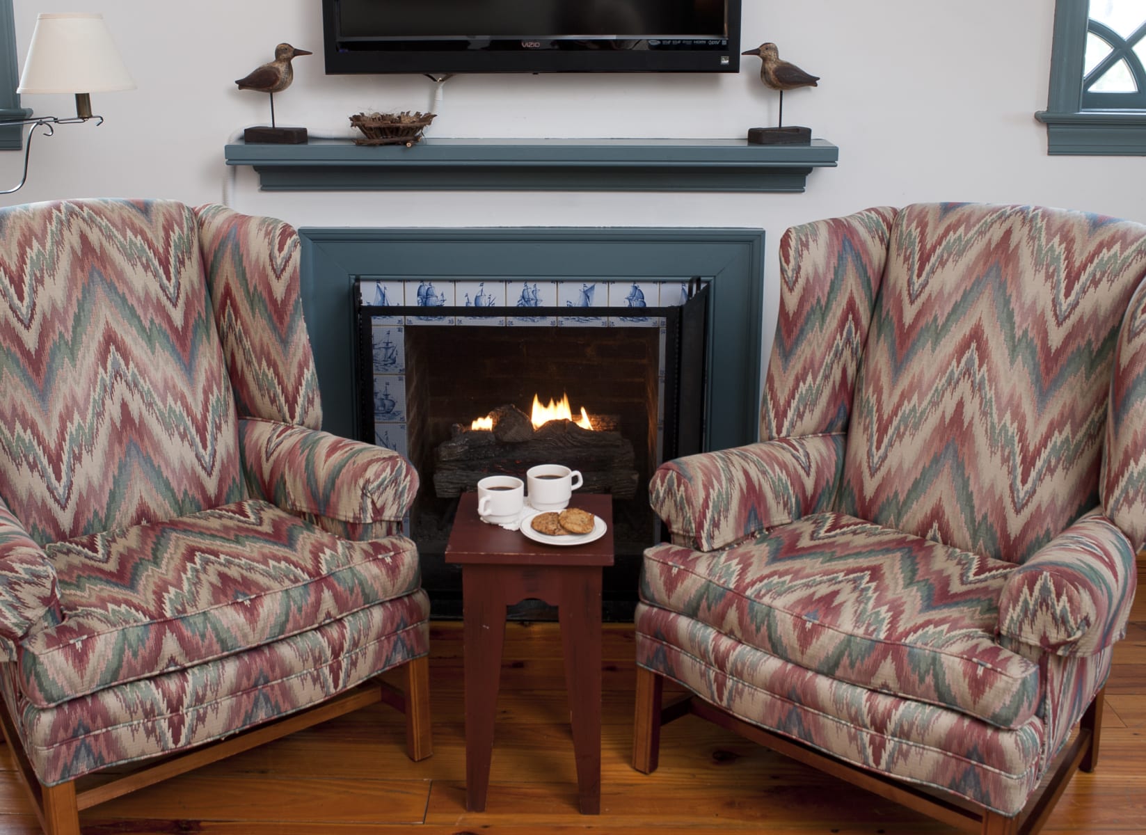 Arm chairs near fireplace.