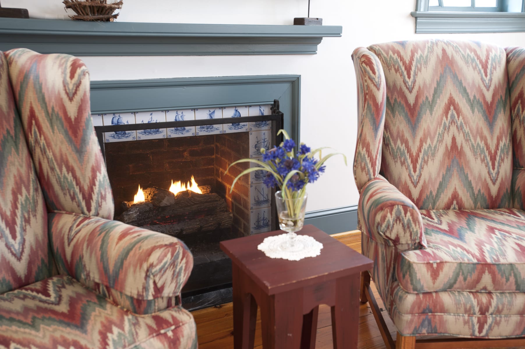 Arm chairs near fireplace.