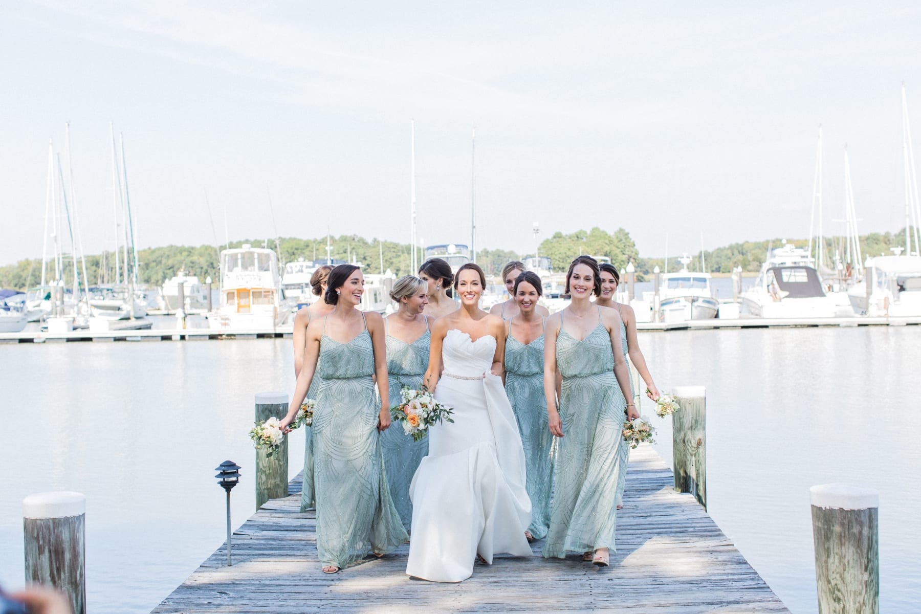 Bride and bridesmaids on dock.