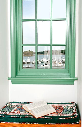 Green framed window looking out to marina.