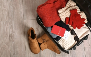 A suitcase packed with sweaters and winter gear for a weekend getaway in Maryland