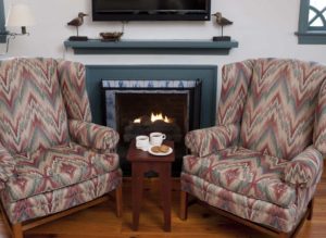 Cozy seating near a fireplace at Osprey Point Inn on the Chesapeake Bay on a winter day