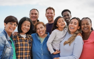 A multigenerational family posing and smiling during a vacation to Rock Hall, MD