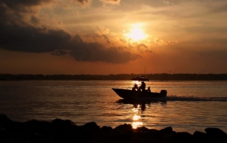 A man on a fishing boat cruising the Chesapeake Bay on a boating vacation