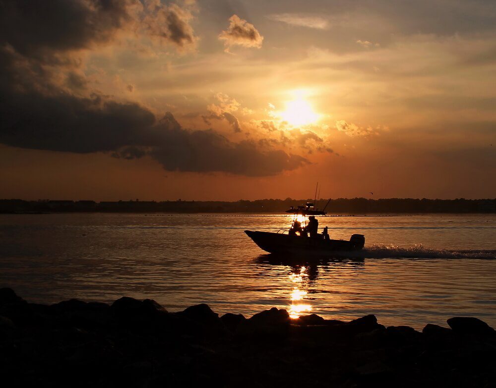 A man on a fishing boat cruising the Chesapeake Bay on a boating vacation